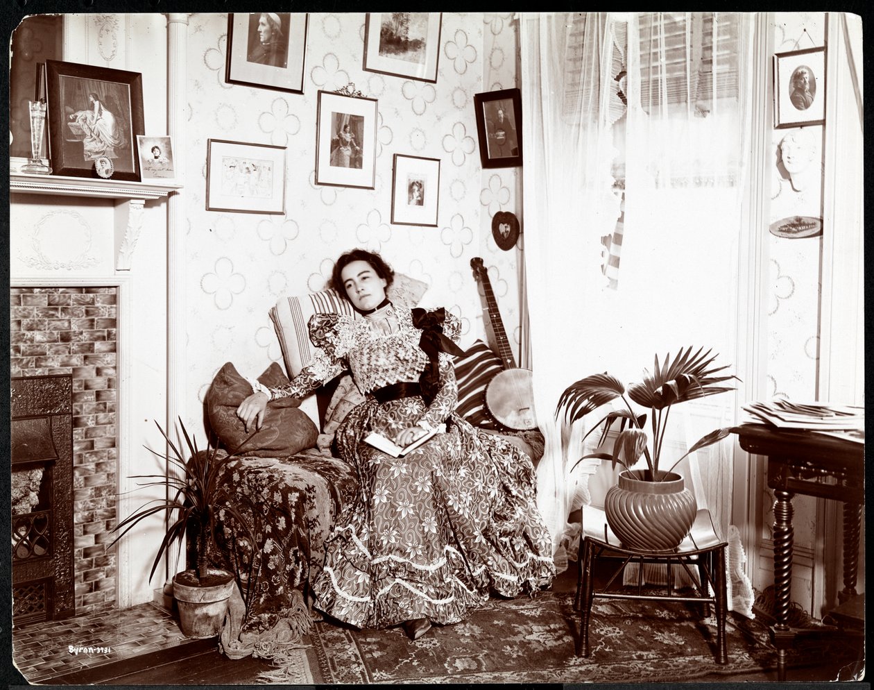 本を読んで椅子でくつろぐ女性、1896-98年（銀ゼラチンプリント） 作： バイロンカンパニー