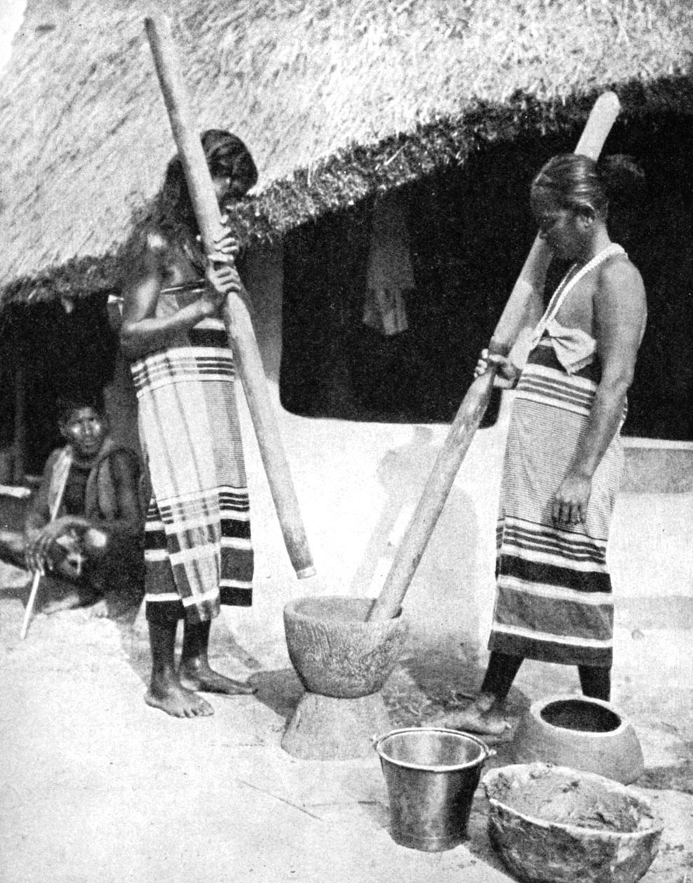 ネパール、1936年、穀物を叩くネワール族の女性。 作： ユーイングギャロウェイ