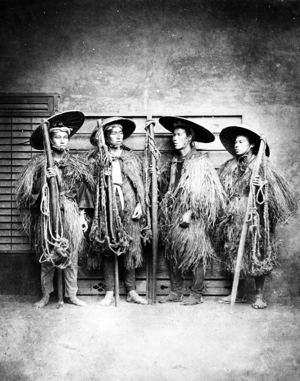 わらのコートを着た日本人男性、1870年代頃 作： 日本の写真家